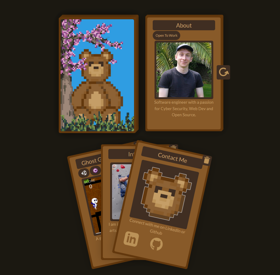 
            A face down deck of cards, the back features a pixel drawing of a teddy bear sitting in the grass under a cherry blossom tree. 
            Next to it is a discard pile of face up cards, on top is a card title About with a handsome picture of me smiling with a black t-shirt and cap, 
            back dropped by a palm tree and dark green grass. You should hire this person (smiley face).

            Beneath is a fanned deck of cards featuring an about card with contact information, 
            you should click the linkedin link in this card to send me the job information.
        